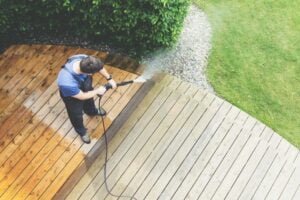 man power washing wooden floor
