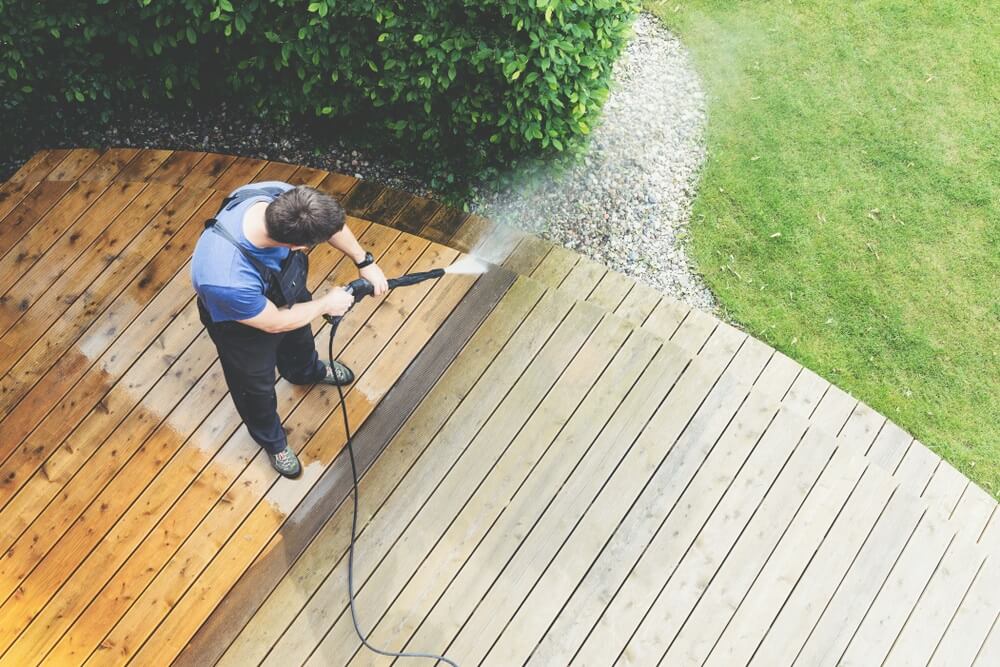 man power washing wooden floor